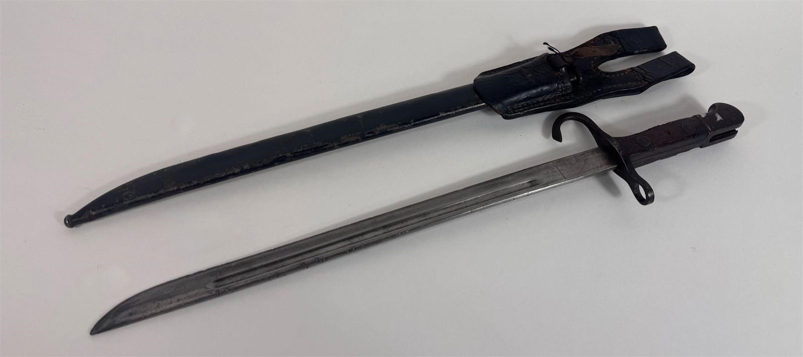 WWII Japanese Type 30 Bayonet with Frog: his is a Japanese Type 30 bayonet made by Toyoda Automatic Loom Works. The blade of this bayonet has almost all of its original bluing left. The bluing is missing from areas commonly associated with s