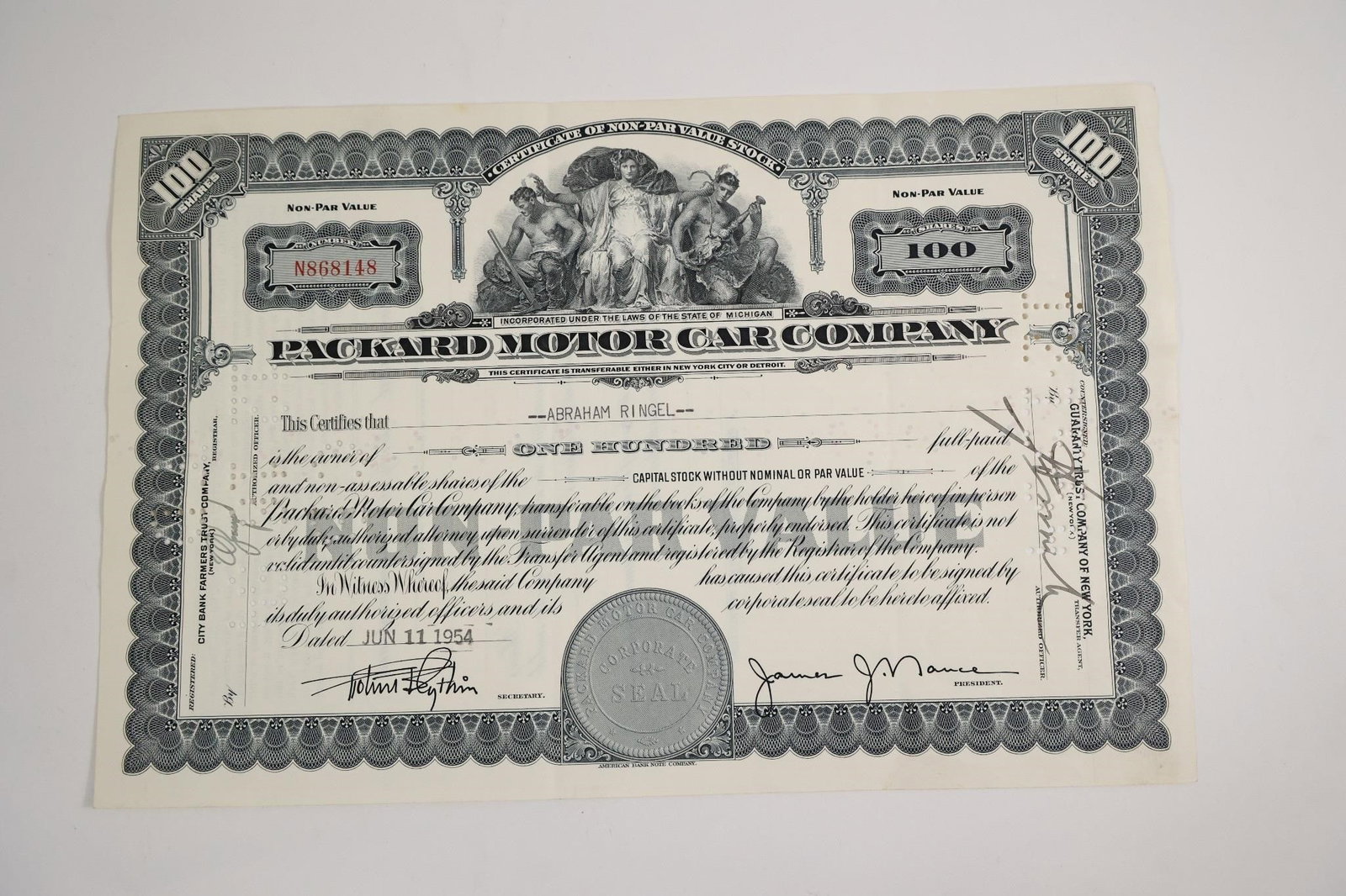 Packard Motor Car Company 100-Share: A vintage stock certificate from the Packard Motor Car Company for 100 shares of capital stock without nominal or par value, issued to Abraham Ringel on June 11, 1954.