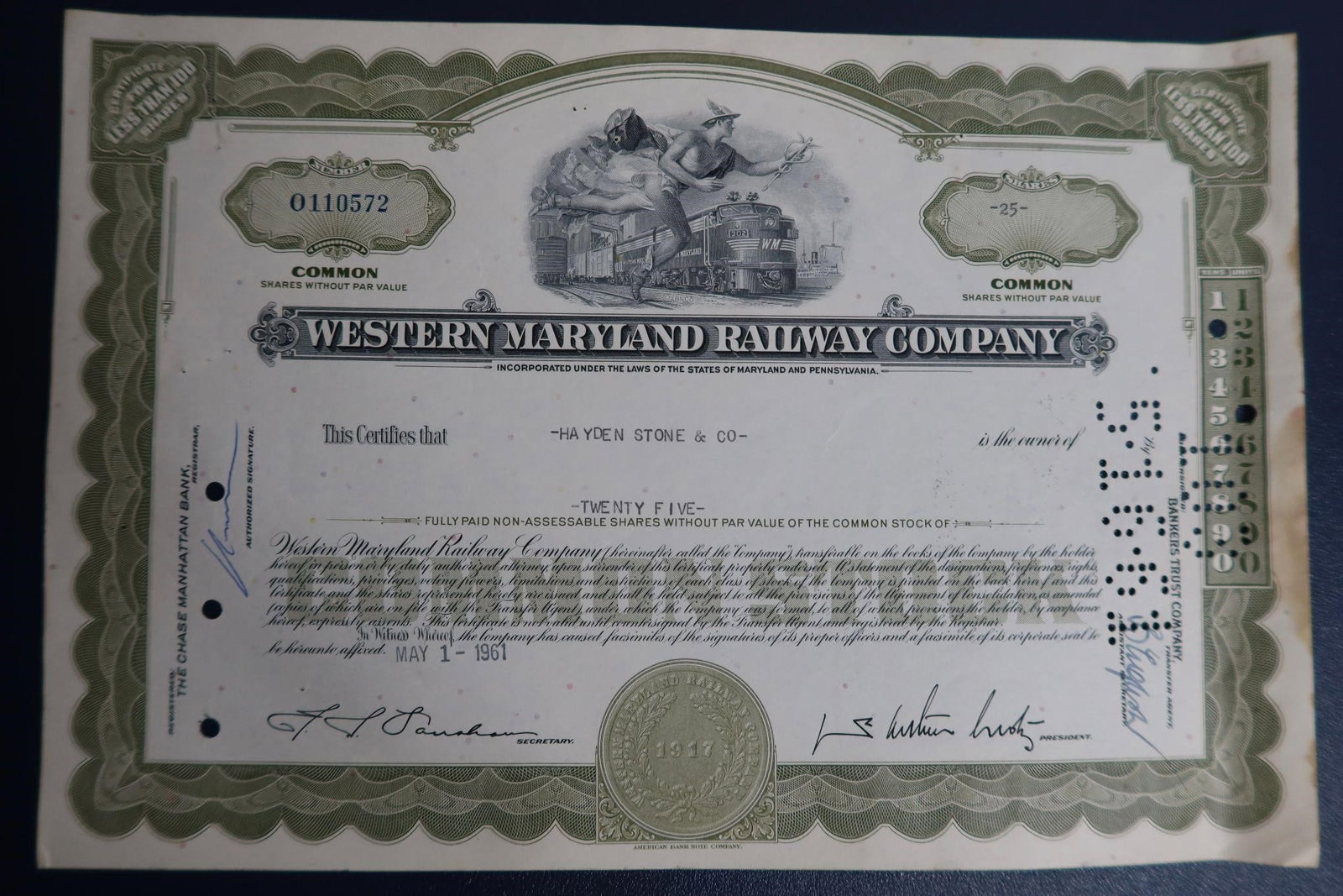 Western Maryland Railway Co Stock Certificate: A vintage Western Maryland Railway Company common stock certificate issued on May 1, 1961. The certificate is for twenty-five fully paid, non-assessable common shares without par value. It was issued