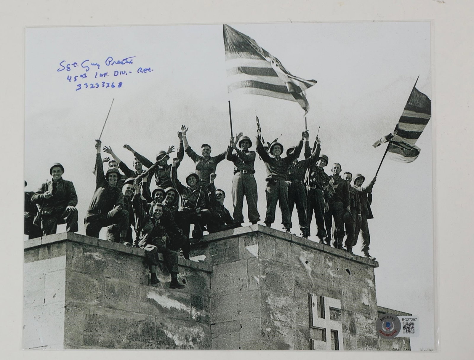 WWII Dachau Liberation - Guy Prestia Signed Photo: WWII - Liberation of the Dachau concentration camp - Guy Prestia - Signed in person w/ Beckett - 2024 Guy Prestia hand signed 25.5 x 20 cm photo. Expertise by Beckett with its unique QRcode number whi
