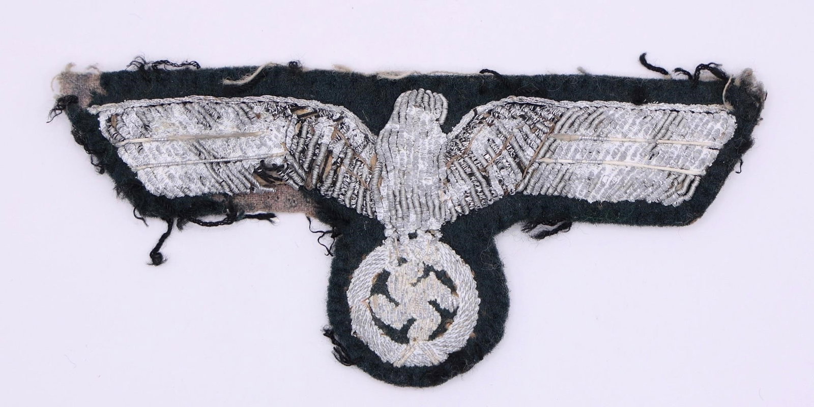 Kriegsmarine Silver Bullion Breast Eagle: Original Kriegsmarine administration breast eagle in silver bullion on dark blue wool. Bullion is in excellent condition with strong shine, high-quality craftsmanship. Period piece from WWII German Na