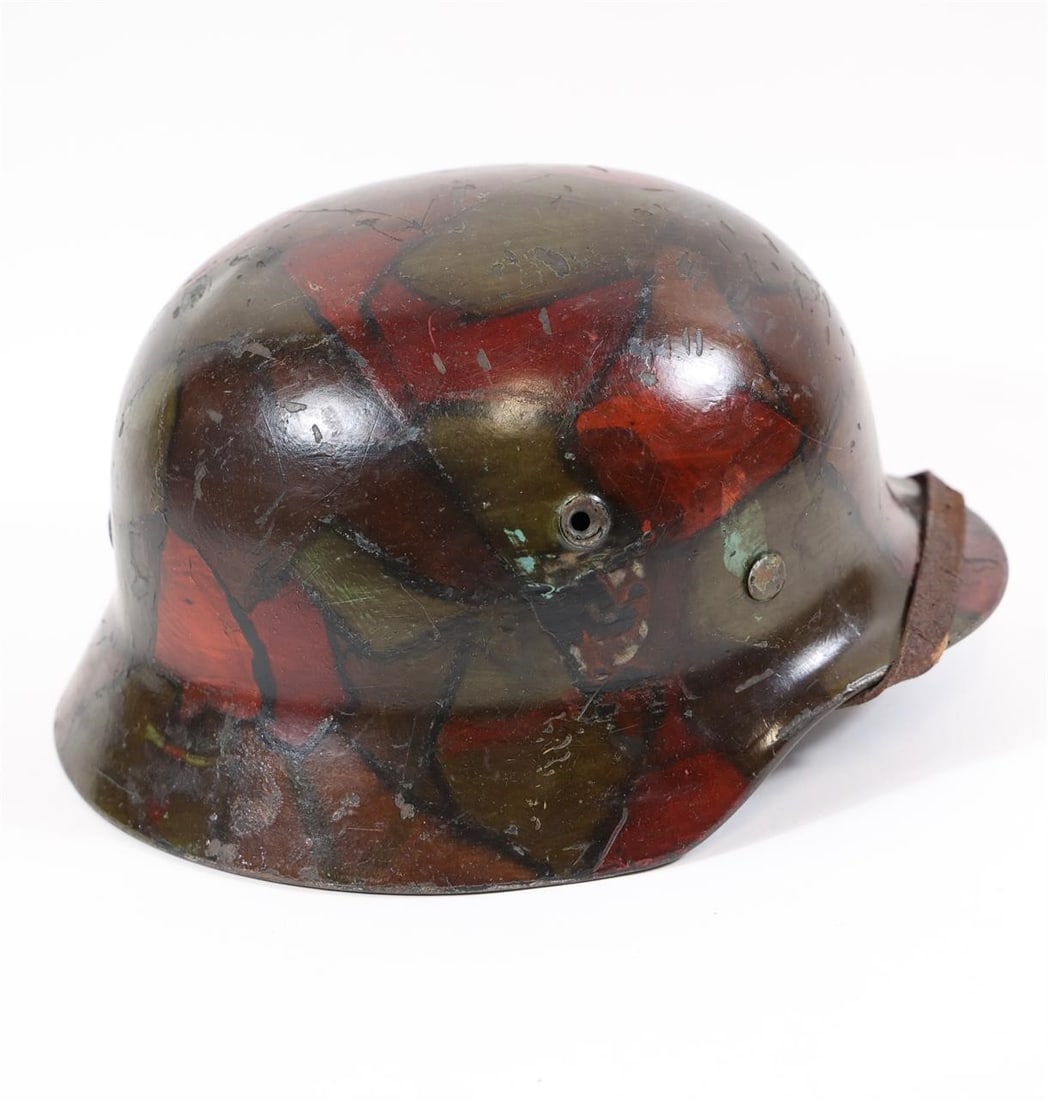 WW2 German M35 Combat Helmet: WW2 German M35 combat helmet featuring the classic rolled-edge design associated with early-war production. Steel construction with age, wear, and patina consistent with period use. A historical