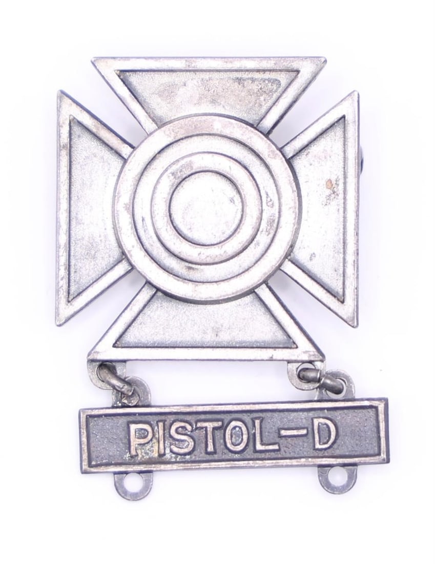 US Army Pistol-D Badge: U.S. Army Sharpshooter Qualification Badge with a "PISTOL - D" qualification bar attached. This badge is a military award for demonstrating marksmanship skills with a specific weapon. The badge is a