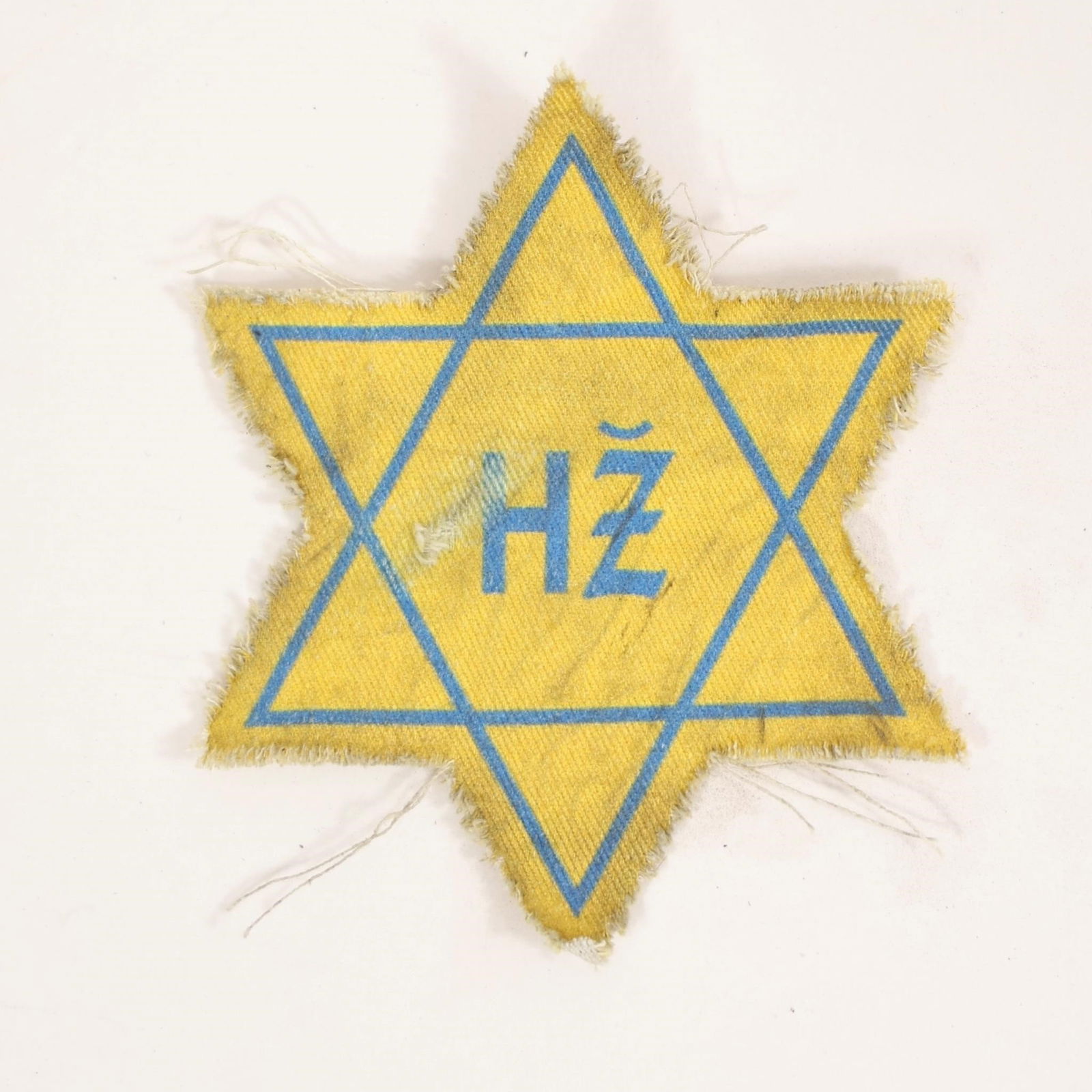 WWII Jewish Star Armband Patch with "H" Marking: World War II yellow Star of David cloth patch, featuring blue outline and "H" lettering at center. Worn on garments to identify Jewish individuals during the Holocaust. Shows age, wear, and fraying co