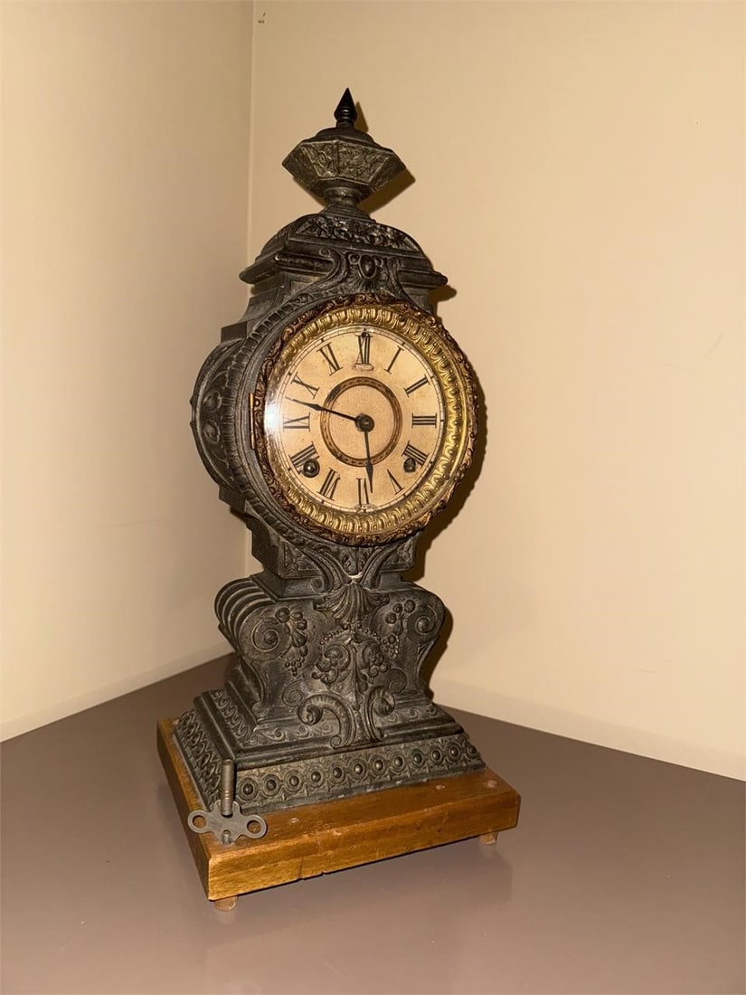 Ansonia Mantle Clock: These clocks are known for their ornate cast metal cases, often featuring intricate details like floral and scroll work.Dimensions: 8x19x8Condition: working, possibly needs cleaning/restoring.