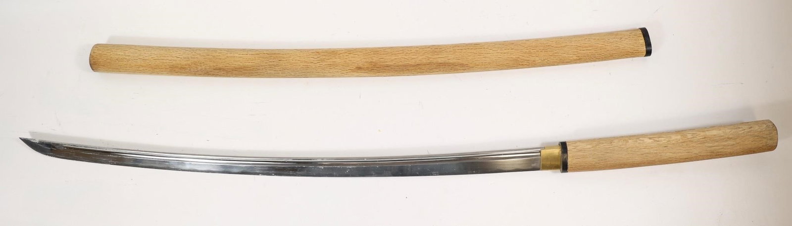 Japanese Katana in Wooden Shirasaya N/M: apanese katana sword featuring a curved steel blade housed in traditional wooden shirasaya mounts (plain wooden handle and scabbard). Minimalist design with natural wood grain and simple fittings, typ