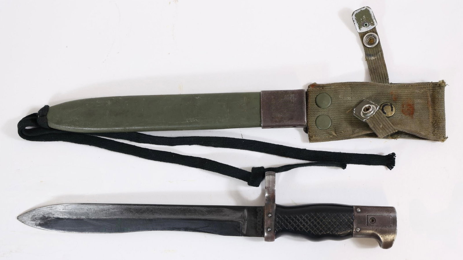 Spanish Military Bayonet w/ Scabbard: Spanish military bayonet with black grip and blade, includes scabbard. Marked "ET 3933 E" on blade. Shows wear and age-related use.Approx. OL: 13"BL: 9"