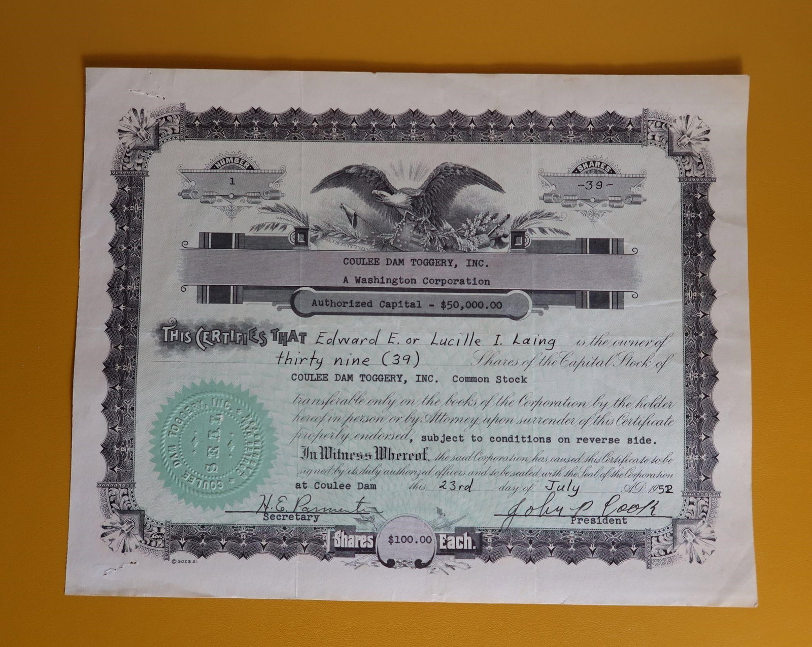 Vintage Coulee Dam Toggery Inc Stock Certificate: Front: A vintage stock certificate for Coulee Dam Toggery, Inc. issued in 1952. The certificate states that Edward E. or Lucille I. Laing is the owner of thirty-nine (39) shares of Common Stock.Each s