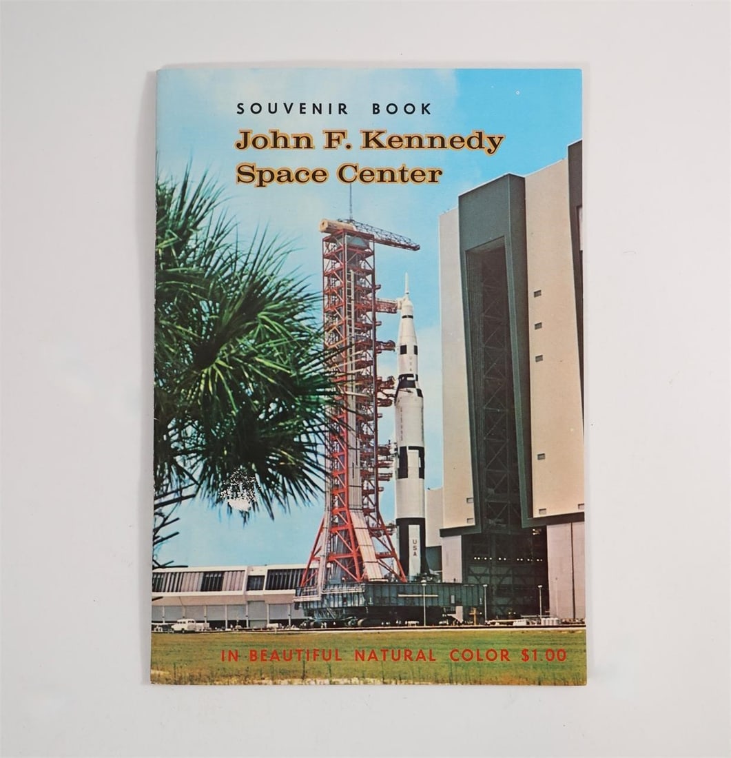 John F. Kennedy Space Center Souvenir Book: Souvenir Book John F. Kennedy Space Center. Front cover shows a rocket on the launch pad with "In Beautiful Natural Color $1.00." Interior pages show the Headquarters Building, Flight Simulator in