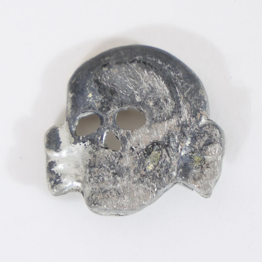 German Waffen SS Totenkopf Skull Cap Insignia: Vintage German Waffen SS visor cap skull insignia, commonly known as the Totenkopf, featuring detailed skull design worn on SS headgear, collectible WWII-era militaria piece.