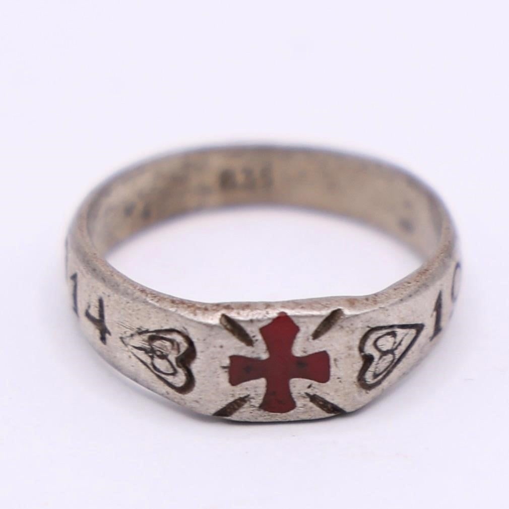 WWI German Silver Ring 1914-1917: WWI German Silver Ring Attractive early 20th-century silver band featuring a red enameled cross at the center and engraved dates "1914" and "1917" on the sides. The ring is marked 835 inside, indicati
