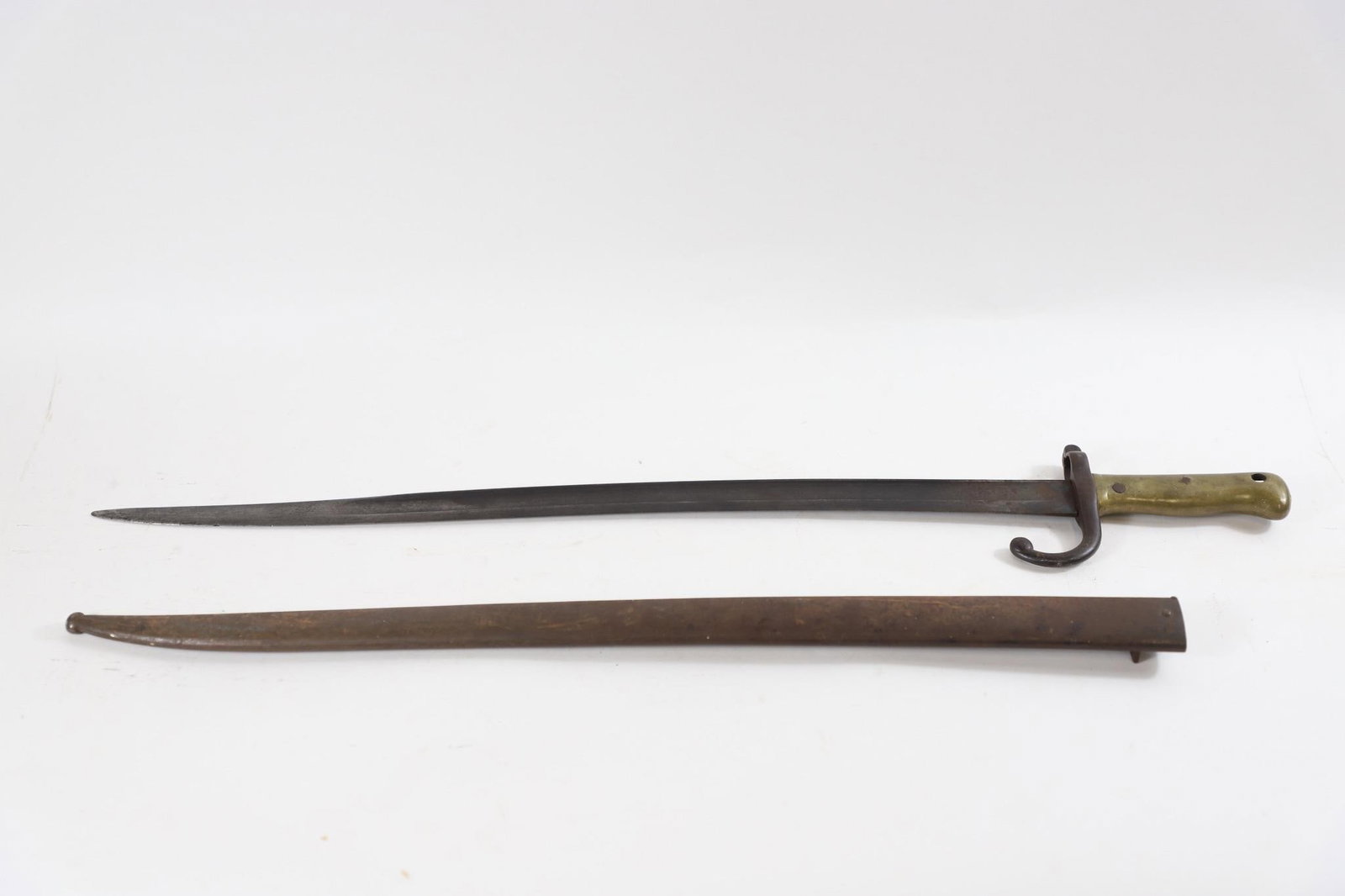 WWI French M1866 Chassepot Bayonet w/Scabbard: French Model 1866 Chassepot bayonet featuring distinctive re-curved yataghan-style blade measuring approximately 22.5 inches with 27.5-inch overall length, solid brass grip and steel crossguard with