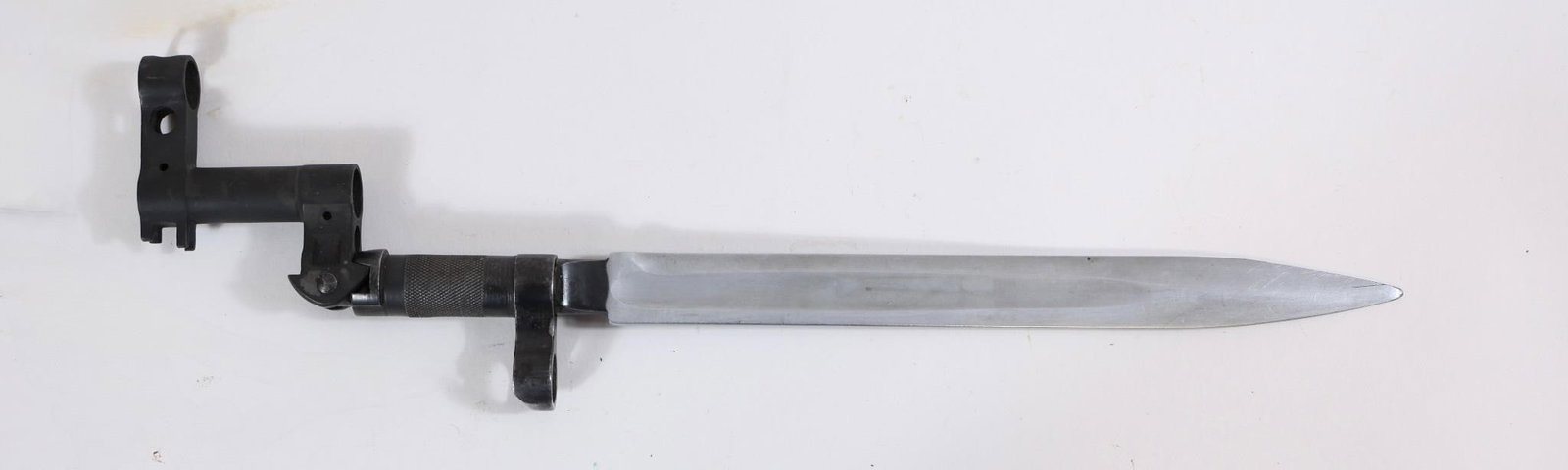 Russian Military Bayonet: Russian military bayonet with metal blade and grip. Shows wear and age-related patina.Approx. OL: 14"BL: 9"