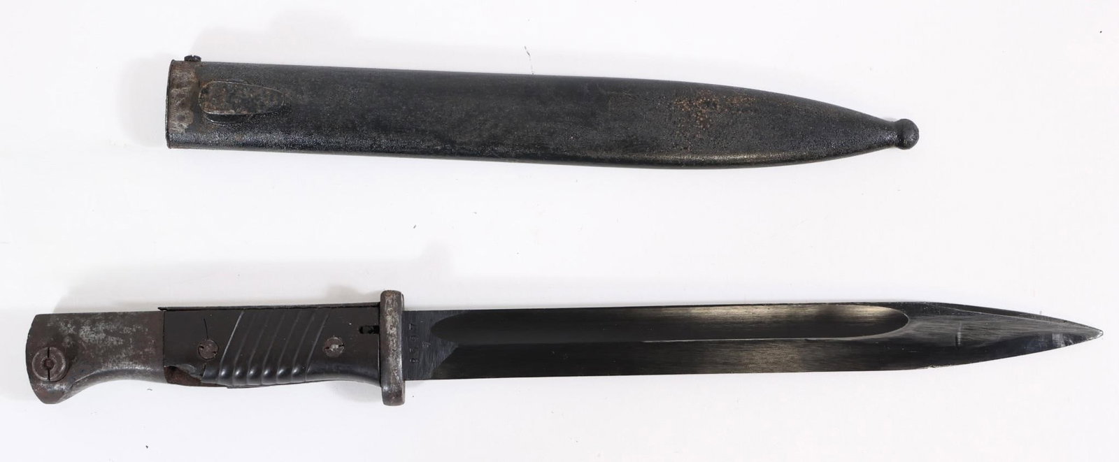 WWII German Military Bayonet w/ Scabbard: WWII German military bayonet featuring a fullered blade and metal hilt with ribbed grip panels. Guard and pommel show age and patina. Blade marked "42ddl" with serial number "8597" visible. Includes m