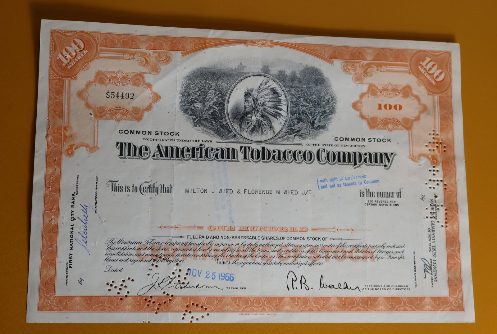 Vintage American Tobacco Company Stock Certificate: A vintage American Tobacco Company stock certificate from 1966, highly prized by collectors as a historical collectible. The certificate is for 100 shares of common stock held by Milton J. Wied & Flor