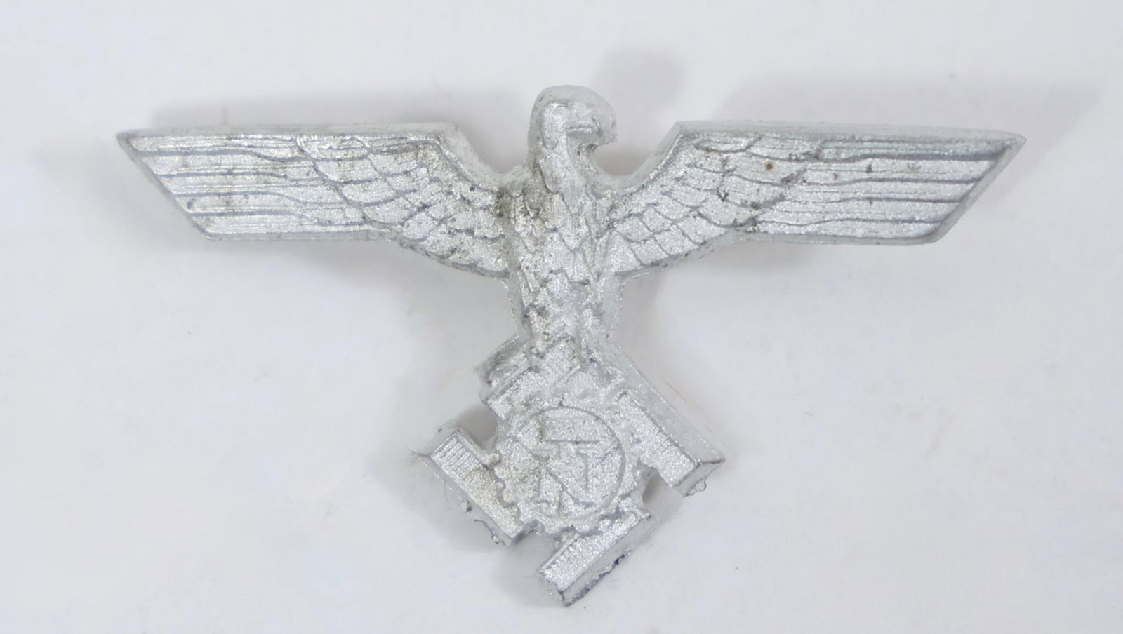 WWII German TeNo Officer Visor Cap Eagle Insignia: This image shows a World War II German Technische Nothilfe (TeNo) officer's visor cap eagle insignia.