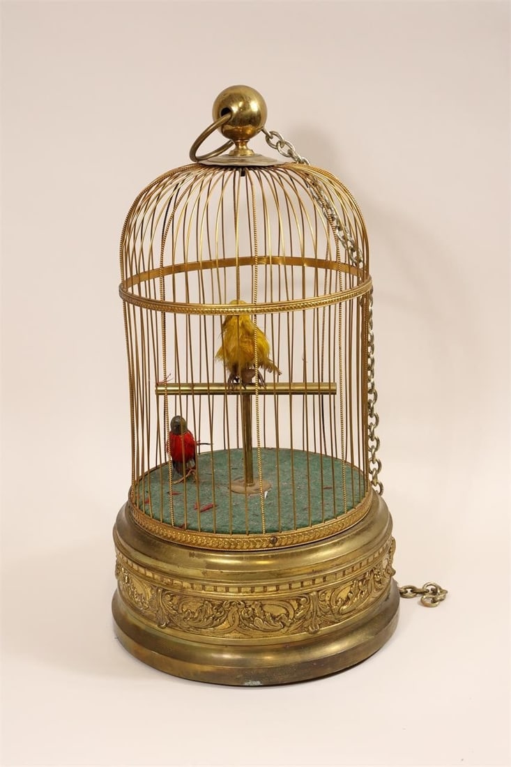 Antique French Double Singing Bird Cage: Antique French double singing bird cage standing approximately 19.5 inches tall, featuring two compartments for mechanical singing birds; ornate metal construction with fine detailing, reflecting