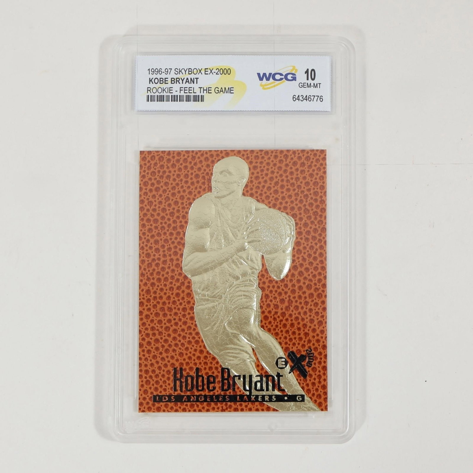 Kobe Bryant 1996-97 EX-2000 Rookie WCG 10: 1996-97 SkyBox EX-2000 Kobe Bryant rookie card "Feel the Game," featuring a gold-foil style embossed design with basketball-textured background. Graded WCG 10 GEM-MT and encapsulated in protective sla