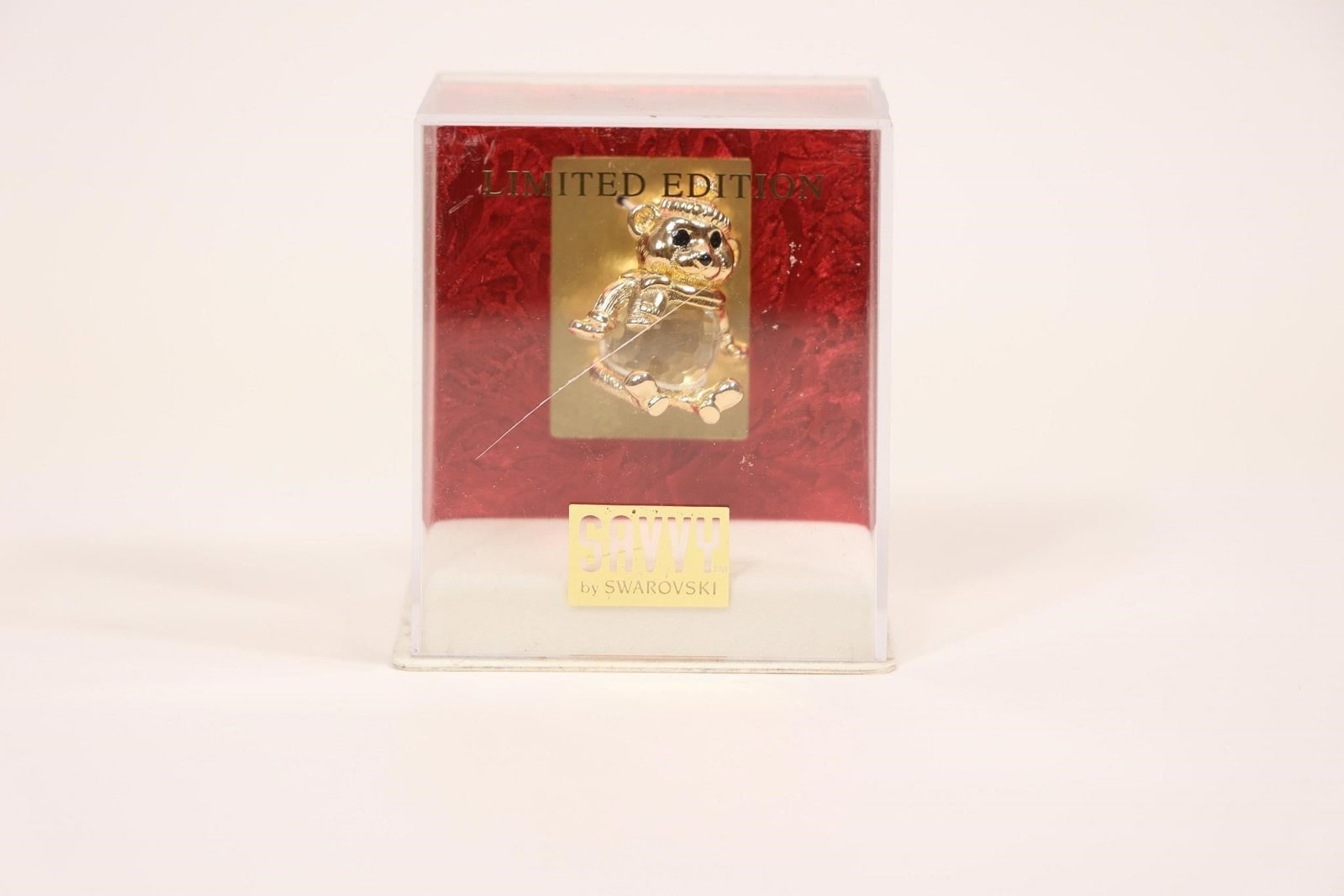 Limited Edition Swarovski Bear Figurine in Box: Collectible glass or crystal bear figurine presented in a red display box marked "LIMITED EDITION"; finely crafted with clear, faceted detailing, making it an attractive decorative piece and desirable