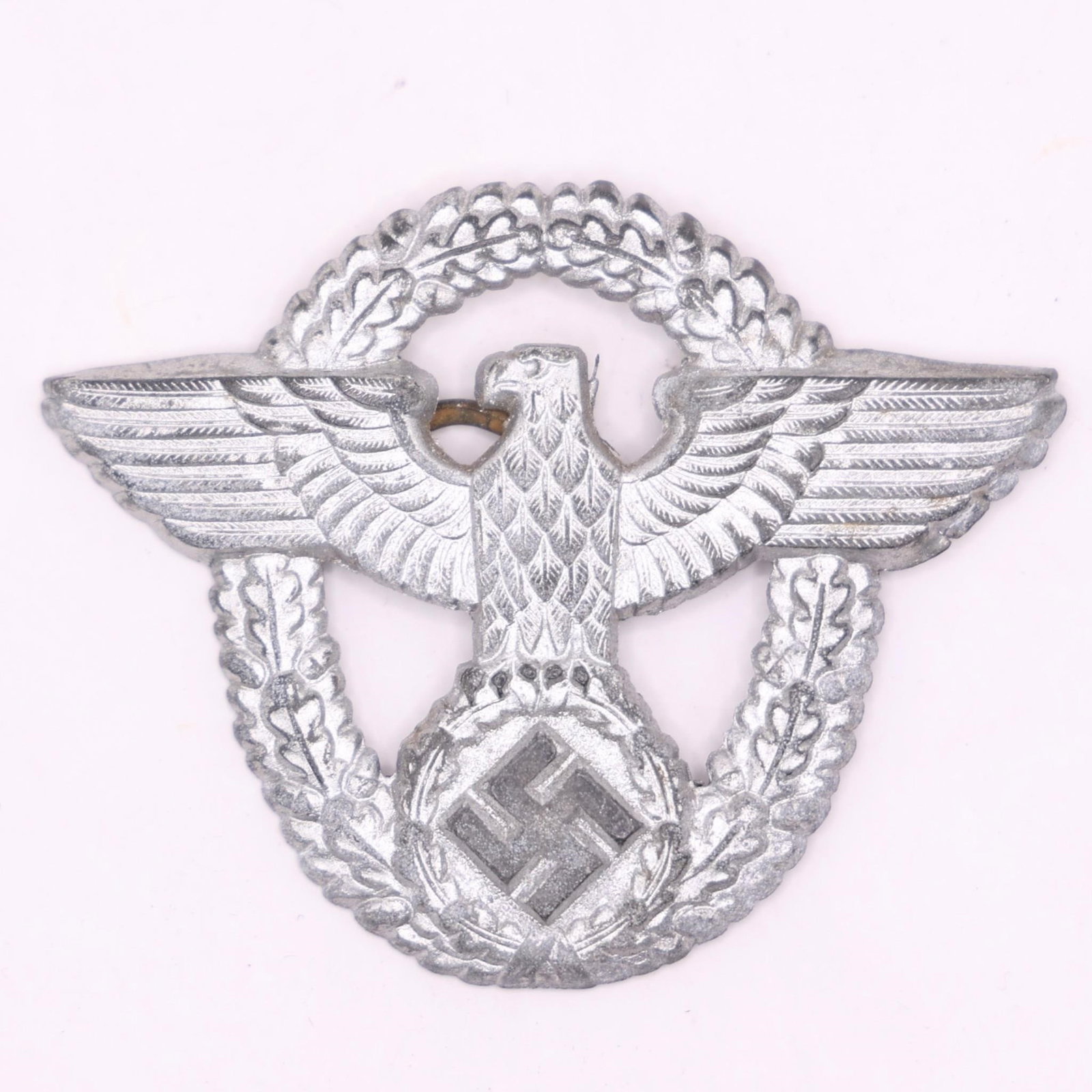 German Police Cap Eagle Badge - Friedrich Linden: Original German police cap eagle badge produced by Friedrich Linden, Lüdenscheid. Period-manufactured example showing honest age-related wear, suitable for a WWII-era police or insignia collection.