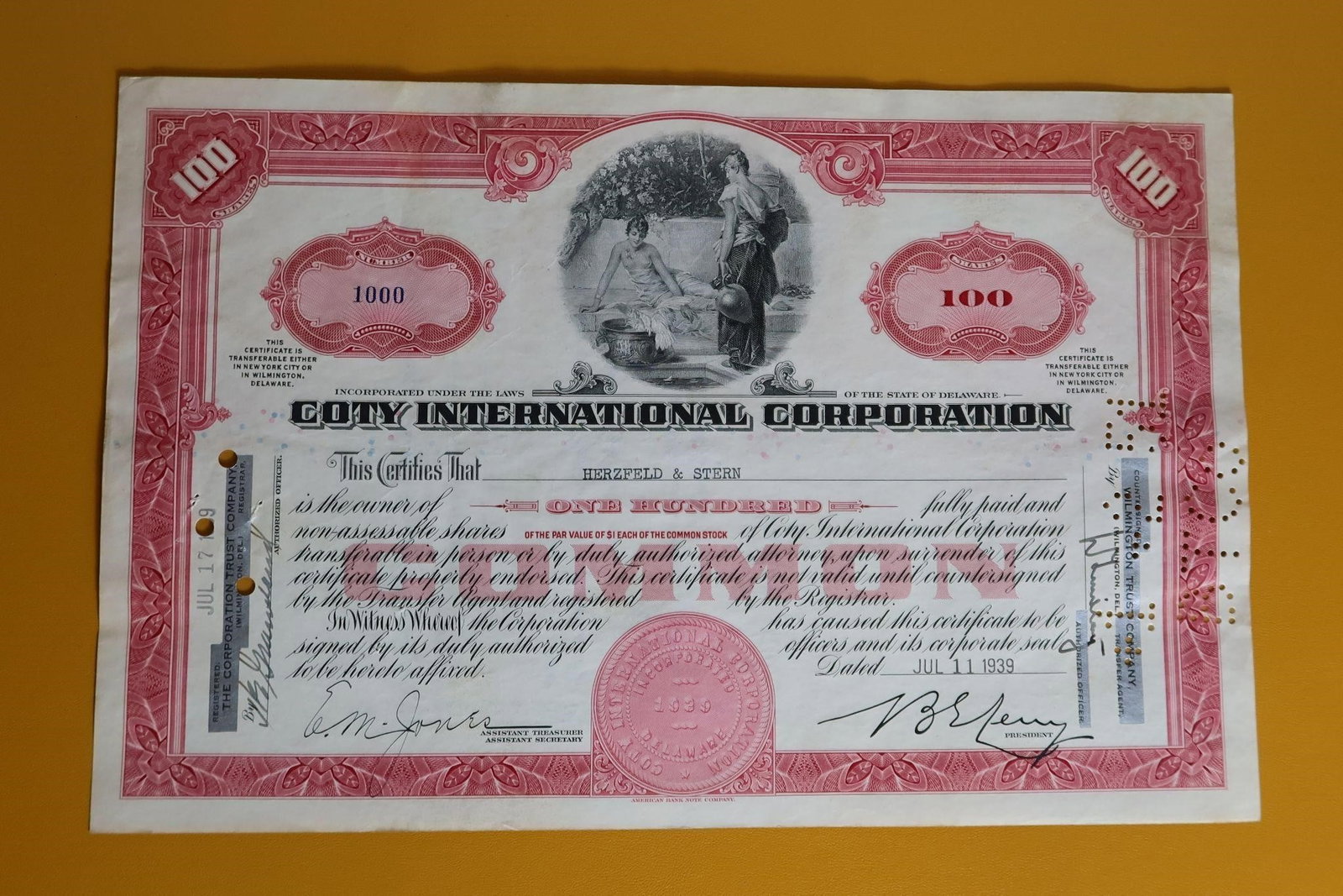 Vintage Coty International Corp. Stock Certificate: A vintage Coty International Corporation common stock certificate. Issued on July 11, 1939, to Herzfeld & Stern, it represents ownership of one hundred fully paid and non-assessable shares. Company: C