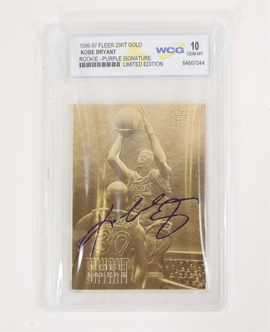 1996-97 Fleer 23KT Gold Kobe Bryant Rookie Card: This item is a 1996-97 Fleer 23KT Gold Kobe Bryant Rookie card featuring a purple facsimile signature. It is graded as Gem-Mint 10 by the World Collectibles Grading (WCG) service. The card is crafted 