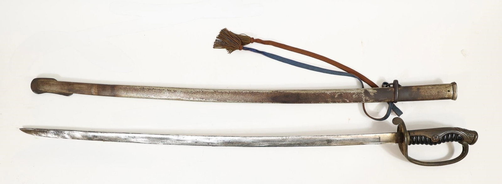 WW II Japan NCO Sword: Military bayonet featuring a D-guard, serial numbered blade with intact chrysanthemum (mum) marking, and steel scabbard. Approximate measurements: 34 1/4" overall length with a 28 3/4" blade. Blade re