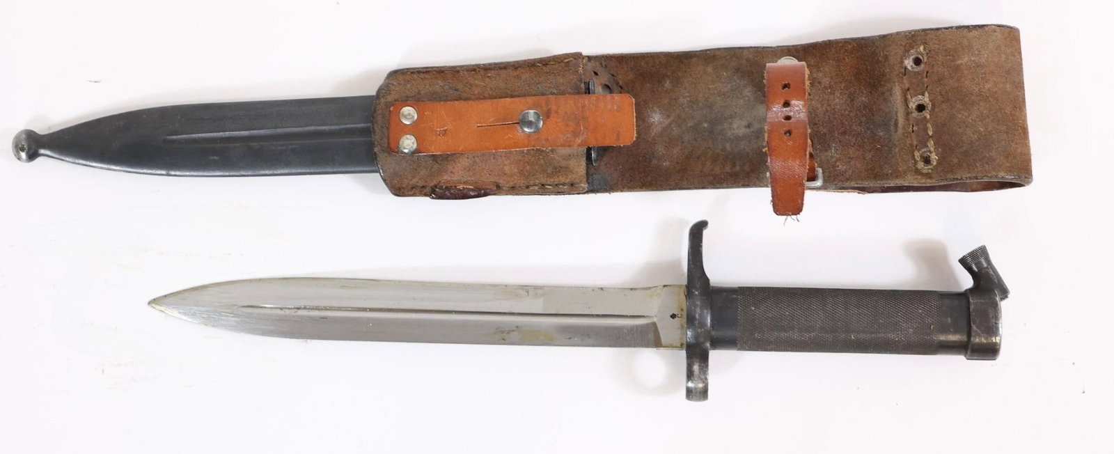 Swedish Military Bayonet w/ Scabbard: Swedish military bayonet with metal handle and blade, includes leather scabbard. Shows wear, patina, and age-related marks.OL: 13"BL: 9"