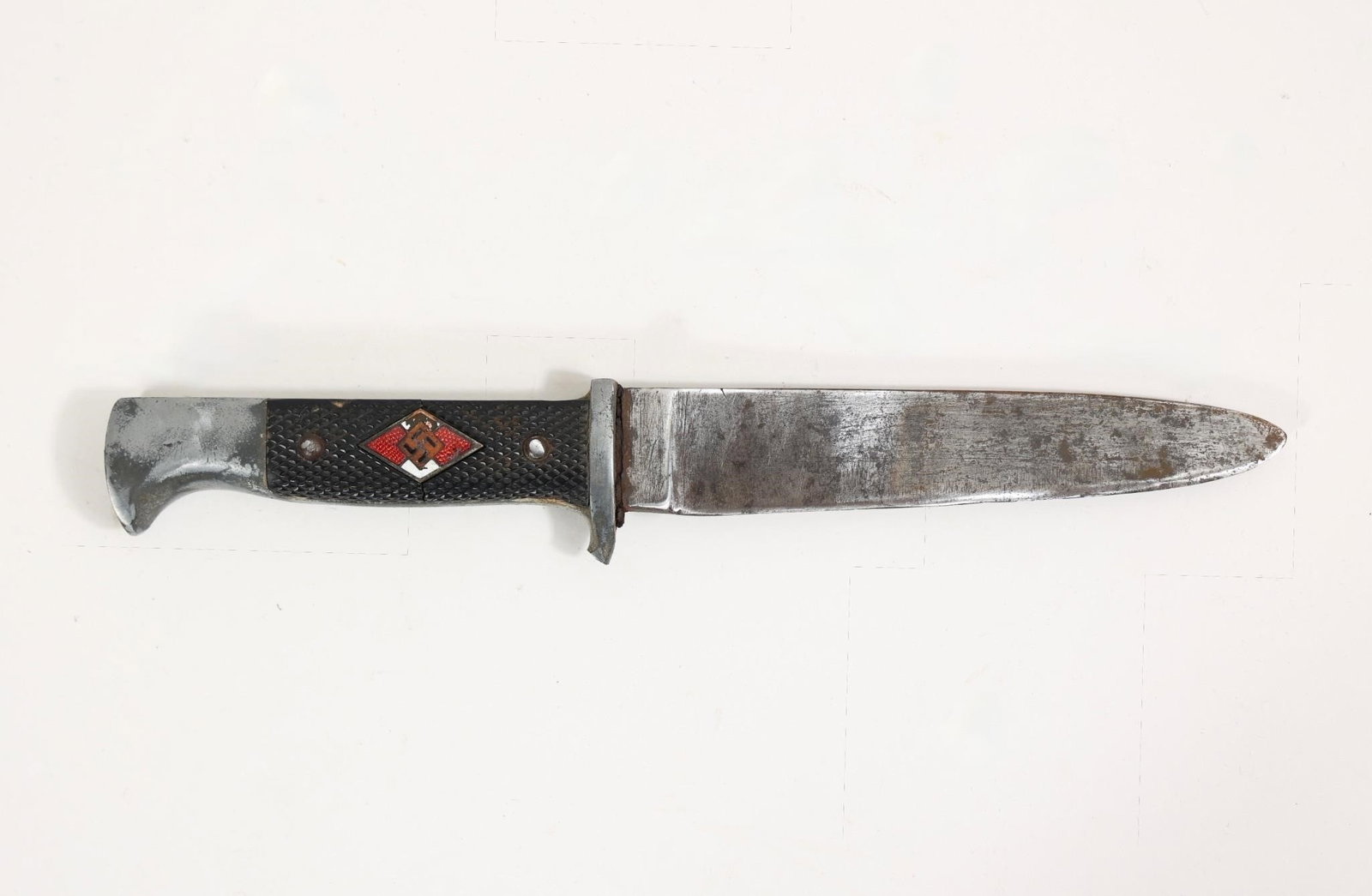 Early HJ Knife: Only one available. Early initial-production HJ knife with a solid steel base and mostly worn nickel plating. Features early closely checkered Bakelite grip plates secured by worn nickel rivets with