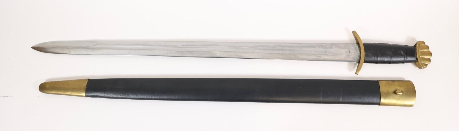 Gladiator Style Sword Decor w/ Scabbard: Gladiator-style short sword featuring a straight blade with fuller, brass guard, and black grip with brass pommel. Includes black scabbard with brass throat and tip. Approximate measurements: 36.5"