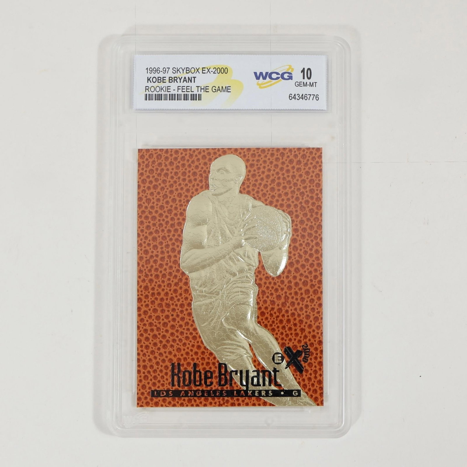Kobe Bryant 1996-97 EX-2000 Rookie WCG 10: 1996-97 SkyBox EX-2000 Kobe Bryant rookie card "Feel the Game," featuring a gold-foil style embossed design with basketball-textured background. Graded WCG 10 GEM-MT and encapsulated in protective