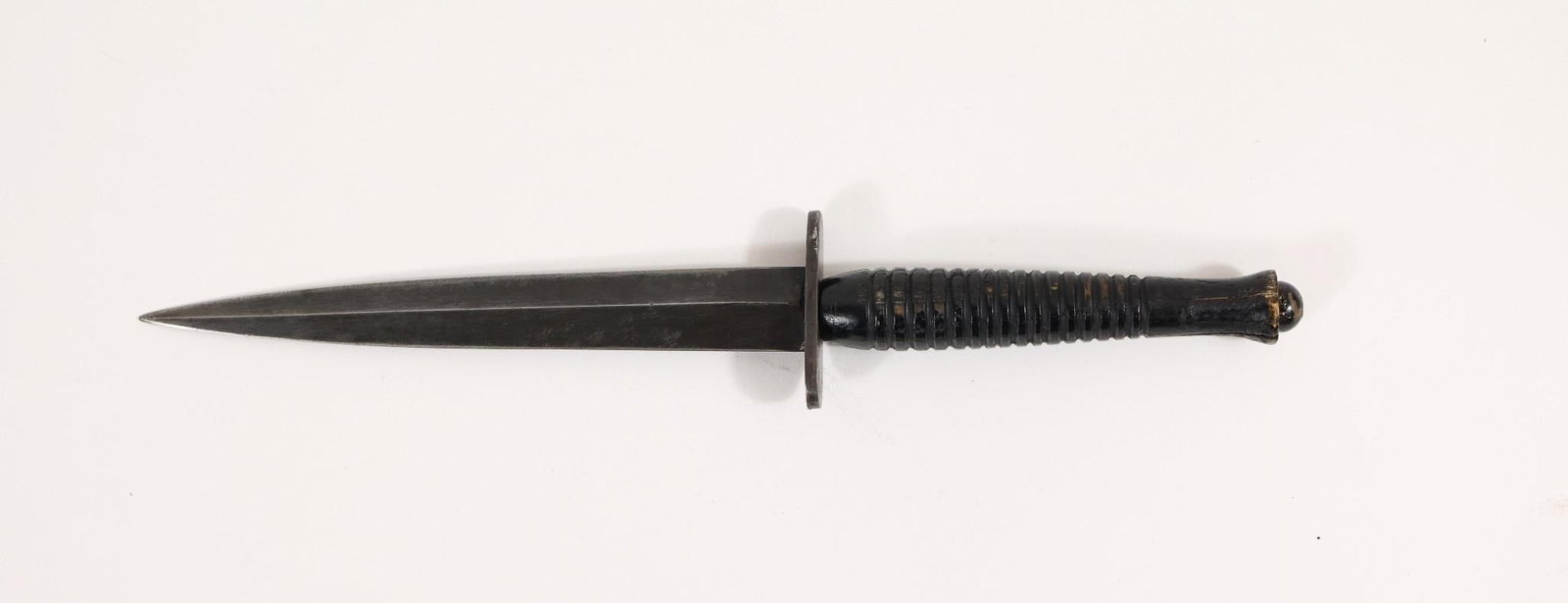 WWII THIRD PATTERN FAIBAIRN SYKES TROPICAL KNIFE: WWII era Third Pattern Fairbairn Sykes Tropical Fighting Knife. Double edged, blued blade. No visible marks. Blued steel 2" oval crossguard. Ribbed wood handle. Blade Length: 6 3/4" Total Length: 11