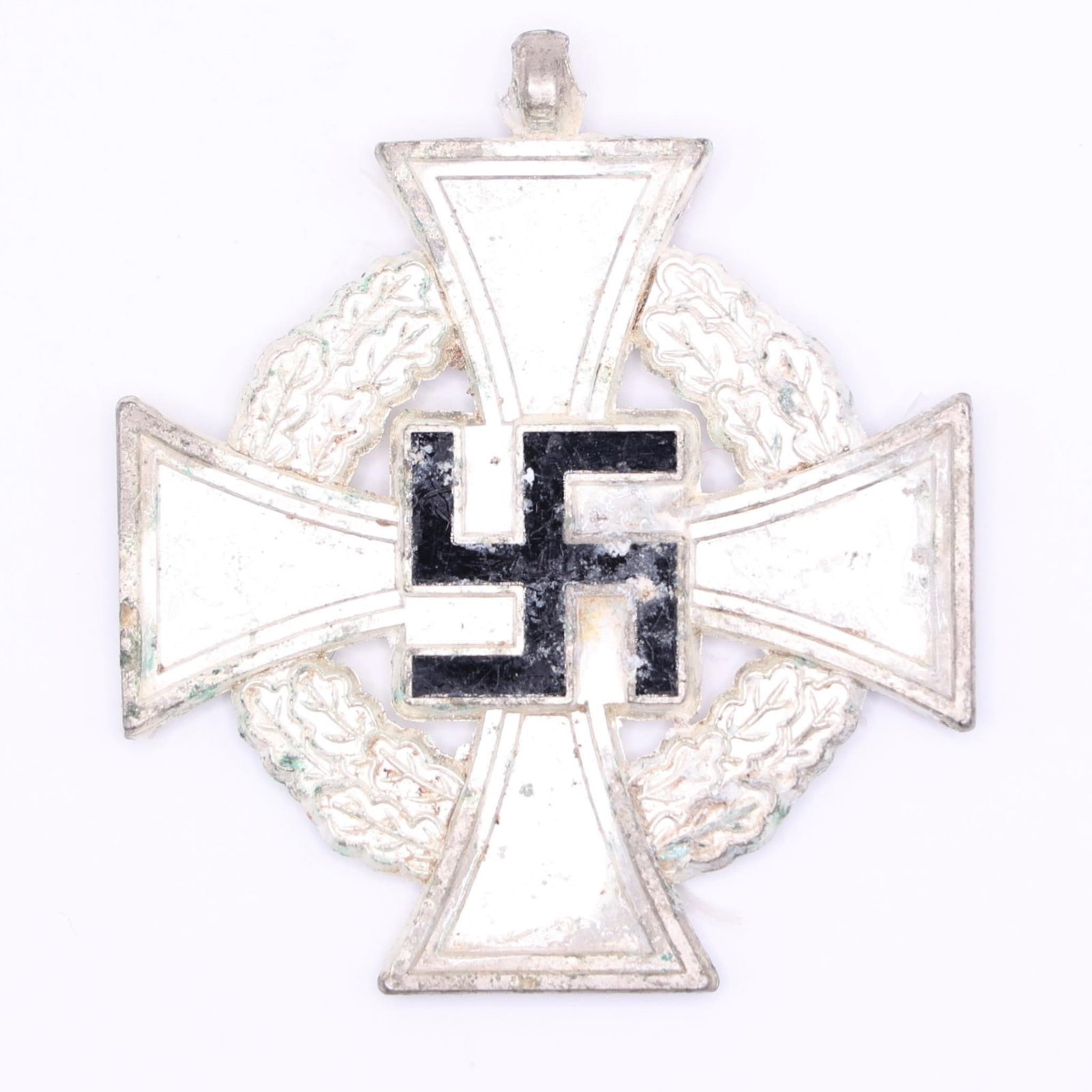 Original 25-Year National Faithful Service Medal: Silvered bronze medal with blue ribbon, measuring approximately 41 × 41 mm. The obverse displays a silver cross with a black enamel swastika at its center, surrounded by an oak wreath. The reverse be