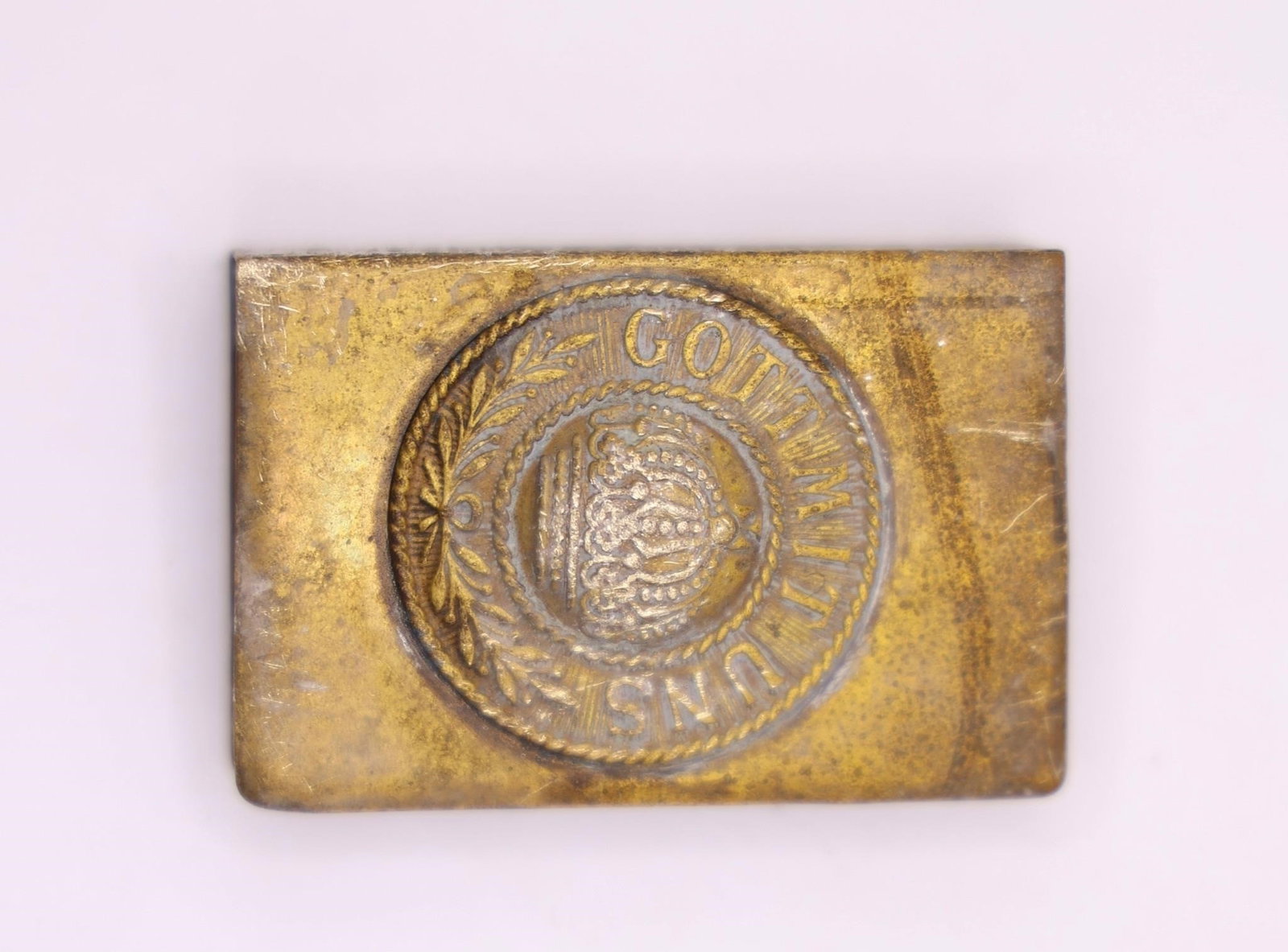 WWI German Military Brass Belt Buckle: A brass belt buckle featuring the famous "Gott Mit Uns" ("God With Us") motto and the Prussian crown, a design commonly associated with German military equipment from the World War I era. Constructed 