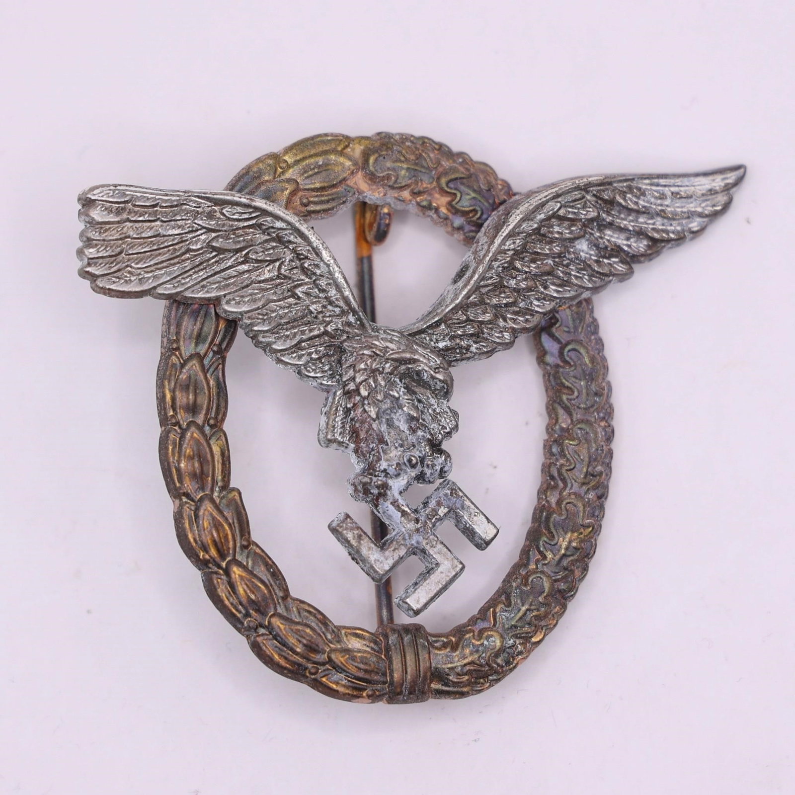 German WWII Luftwaffe Pilot Badge Eagle & Wreath: This German WWII Luftwaffe Pilot Badge features the classic eagle in flight over a laurel and oak leaf wreath.