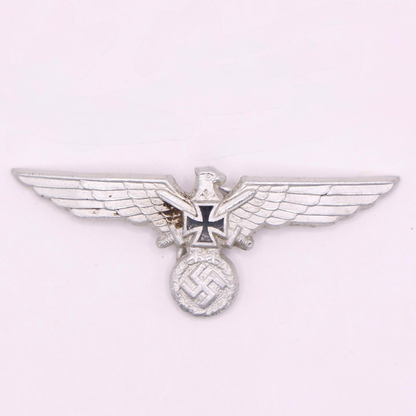 WWII German NS-RKB Member's Breast Eagle: WWII German NS-RKB (National Socialist Reichskriegerbund) member's breast eagle, injection-molded aluminum with silver wash, left-facing eagle clutching a wreathed swastika with Iron Cross and