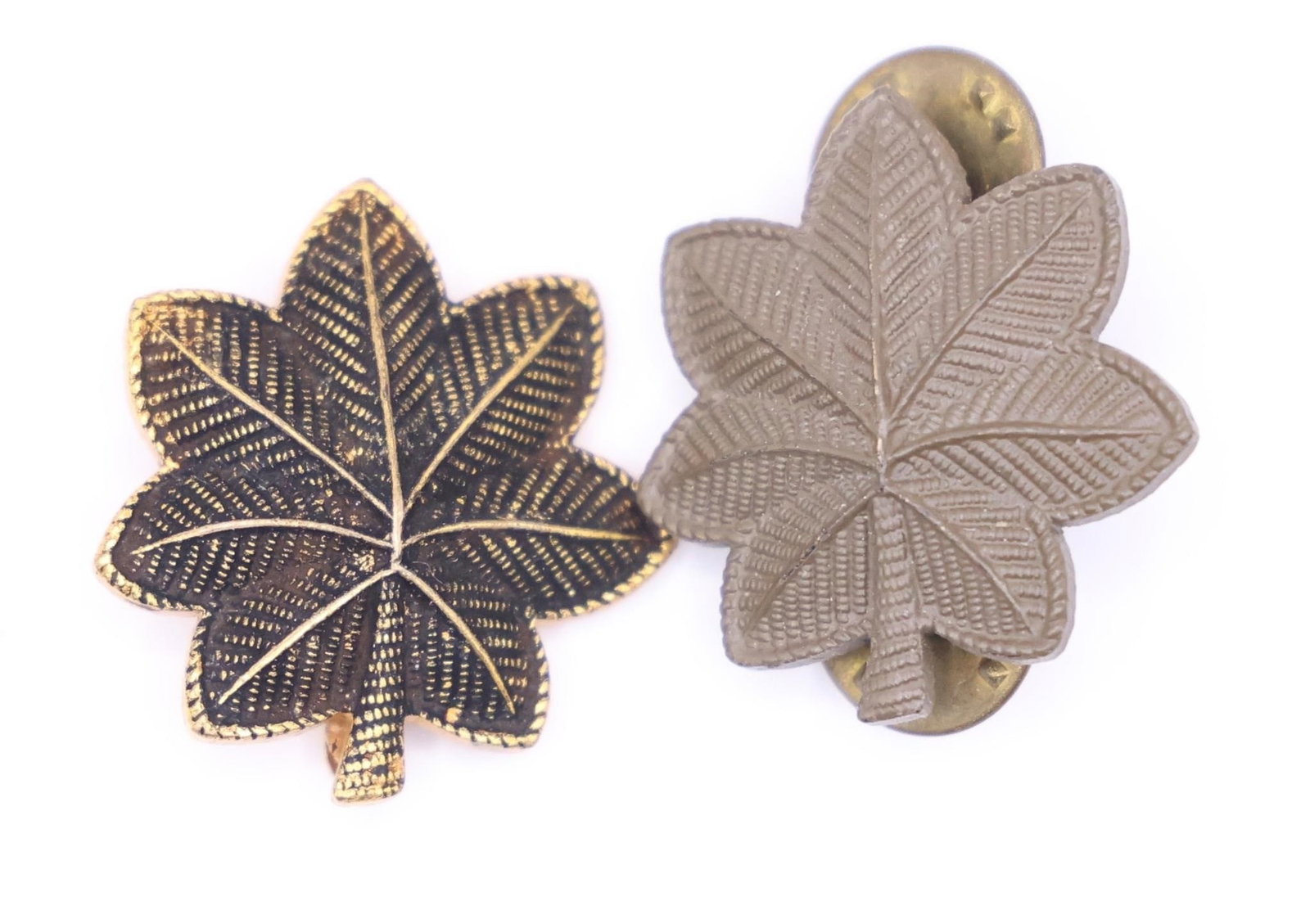WWII Vintage US Army Major Rank Insignia Pins: This is a pair of US Army Major rank insignia pins. The insignia is a gold and subdued brown oak leaf. A gold oak leaf (left pin) signifies the rank of Major (pay grade O-4). A silver oak leaf (not