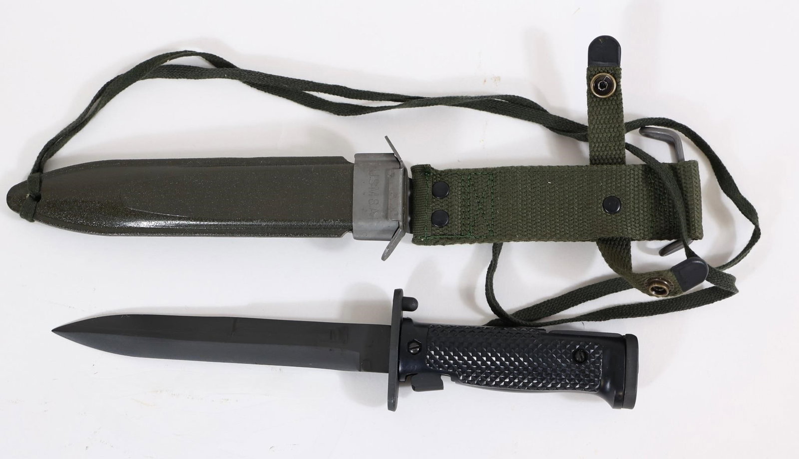 US M5A1 Military Bayonet w/ Scabbard: US M5A1 bayonet with black handle and blade, includes green scabbard with strap. Shows light wear from use and storage.OL: 11.5"BL: 7"
