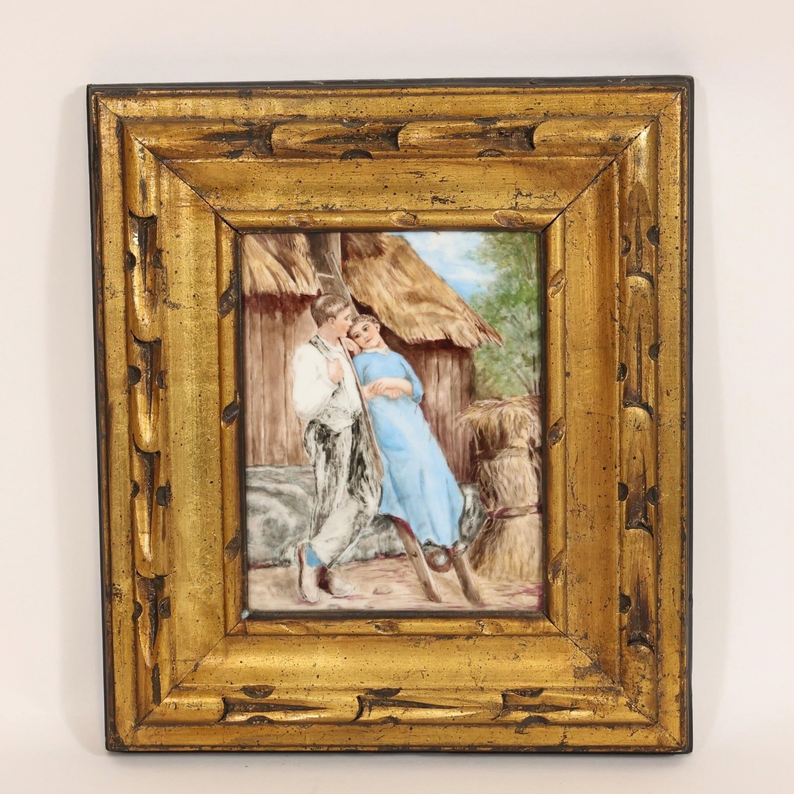 T&V Hand-Painted Porcelain Plaque w/ Gilt Frame: T&V hand-painted porcelain plaque depicting a genre scene with figures in a rustic outdoor setting. Finely detailed with soft coloration and delicate brushwork.Presented in an ornate gilt
