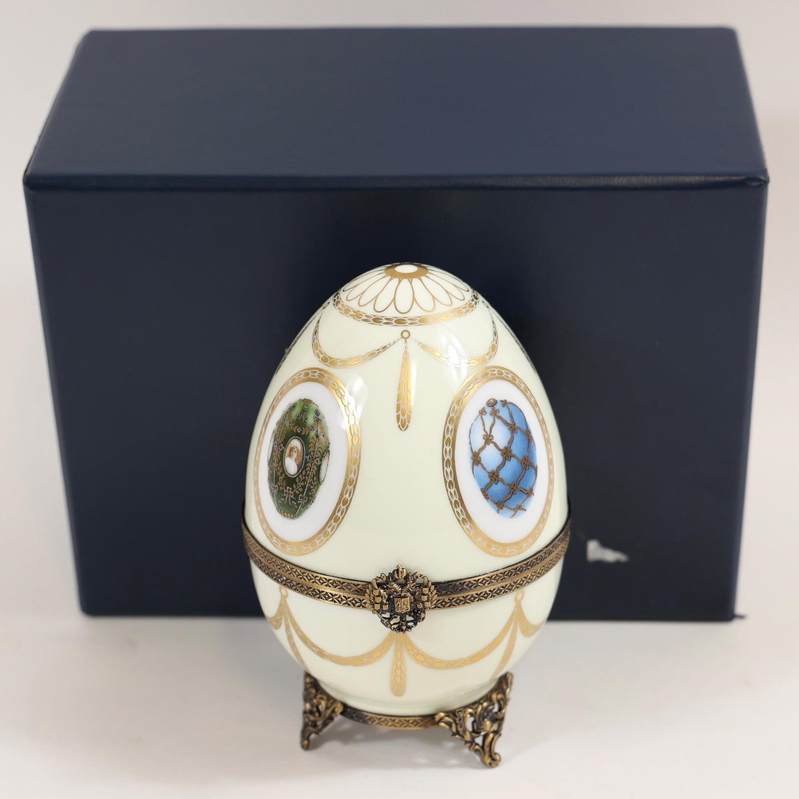 Fabergé Limoges Egg w/ Certificate: Fabergé Limoges porcelain egg accompanied by official certificate with handwritten details and serial number.