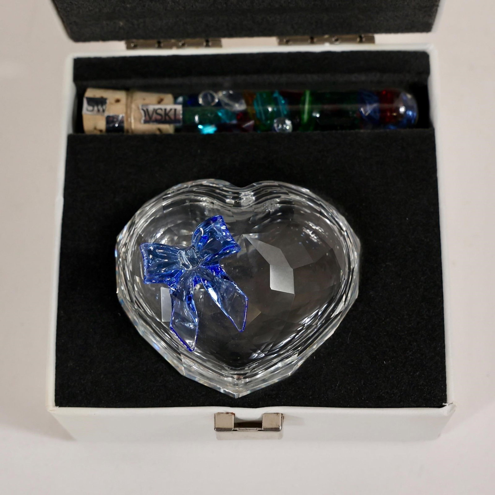 Swarovski Crystal Heart Box: The item pictured is a Swarovski Crystal heart-shaped box featuring a blue bow on top.