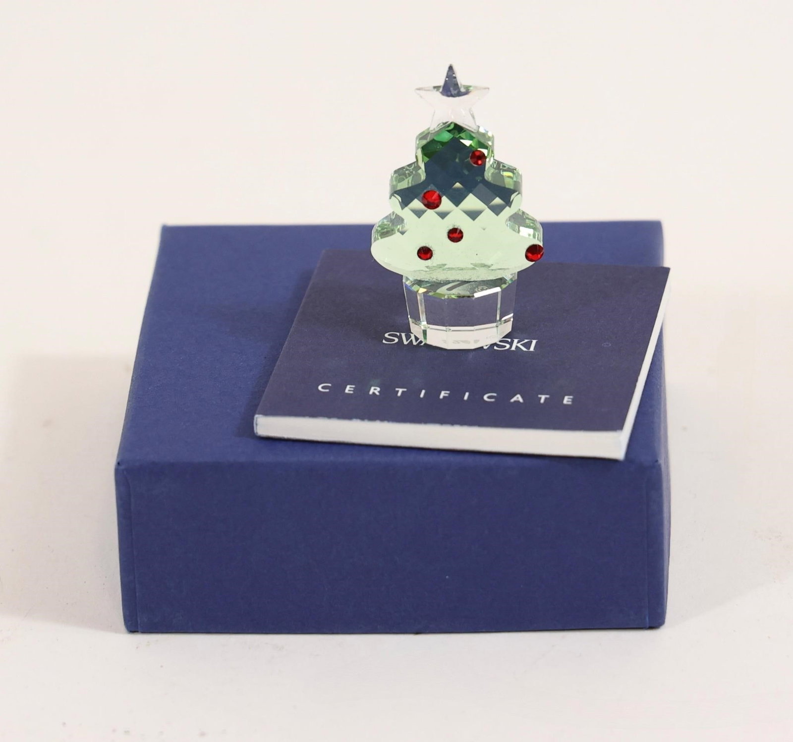 Swarovski Crystal Christmas Tree Figurine: Swarovski crystal Christmas tree figurine with red accents, including original box and certificate.