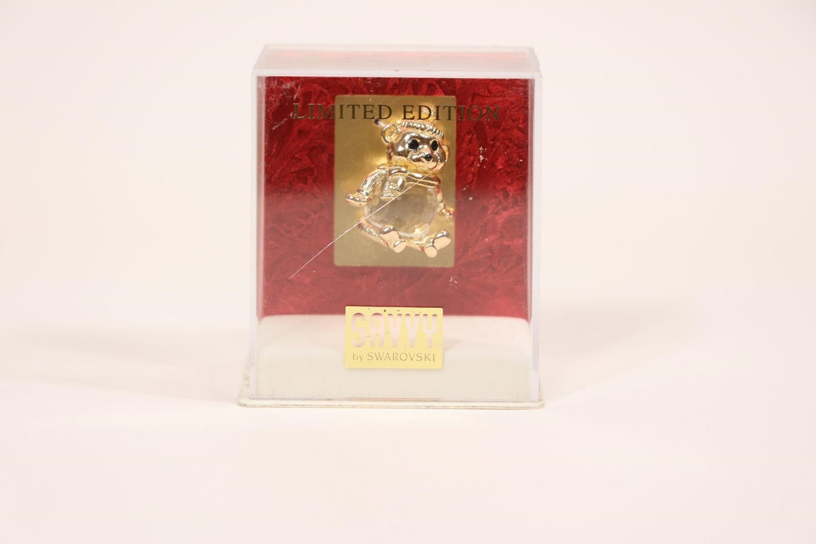Limited Edition Swarovski Bear Figurine in Box: Collectible glass or crystal bear figurine presented in a red display box marked "LIMITED EDITION"; finely crafted with clear, faceted detailing, making it an attractive decorative piece and