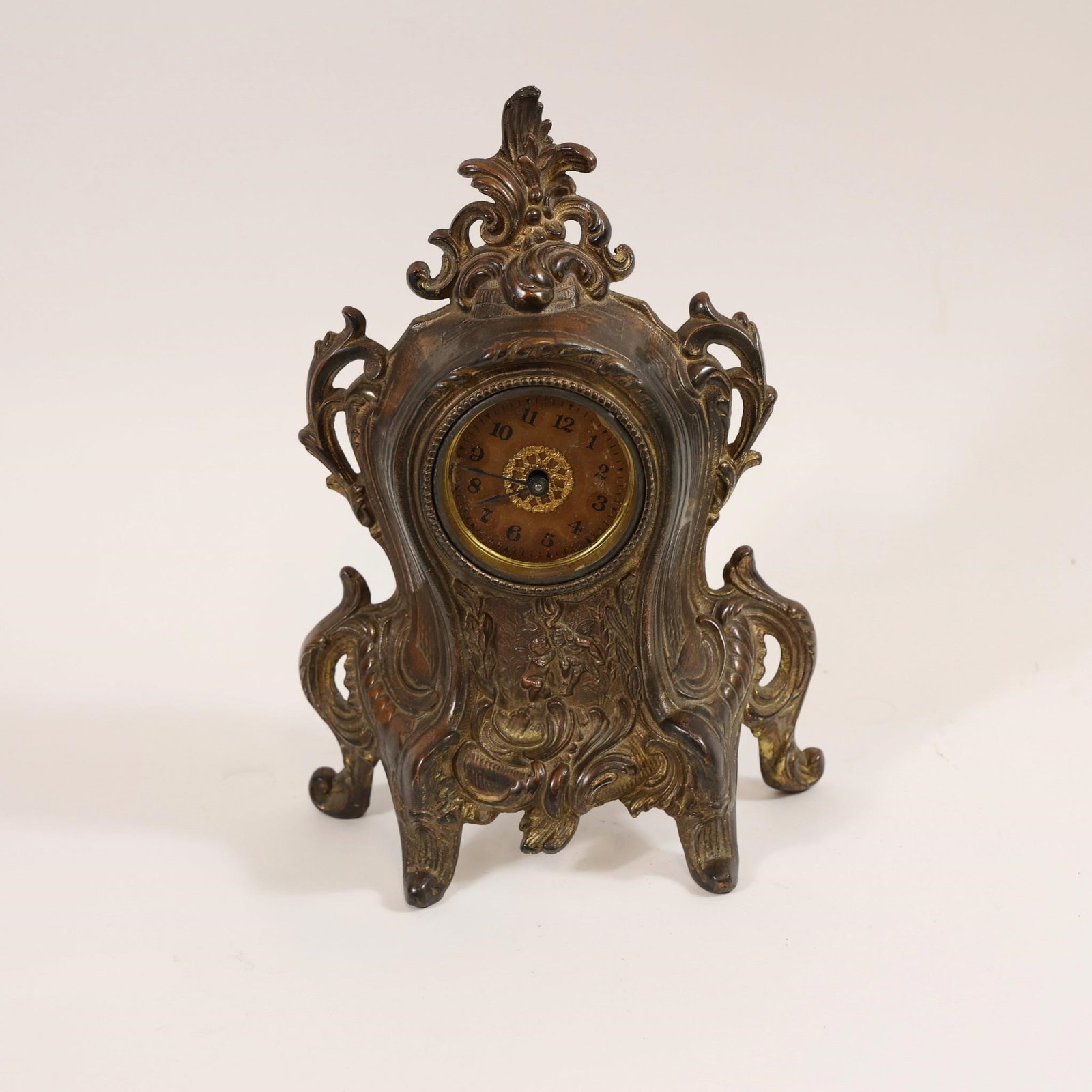 Antique Art Nouveau Mantel Clock: This item is an antique Art Nouveau cast iron or brass mantel clock, often featuring ornate designs and cherub motifs.