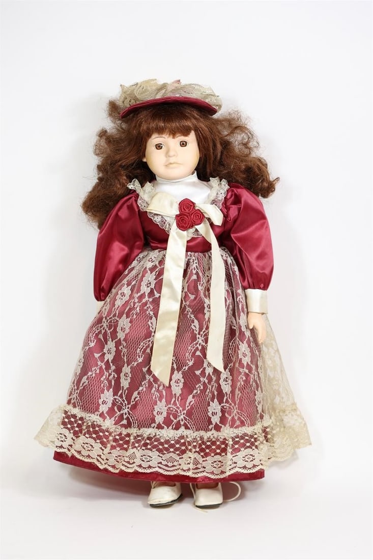 Vintage Porcelain Doll with Lace Dress: Charming porcelain doll featuring a beautifully detailed outfit with lace accents and classic vintage-style design. The doll has a porcelain head, hands, and feet with a soft cloth body, dressed in