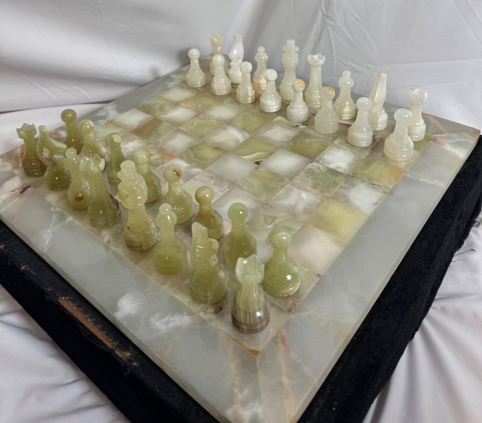 Onyx Chess Set: Both great for playing chess and as a decorative piece.Comes with black velvet box (has several damages)Board dimensions: 16inX16in