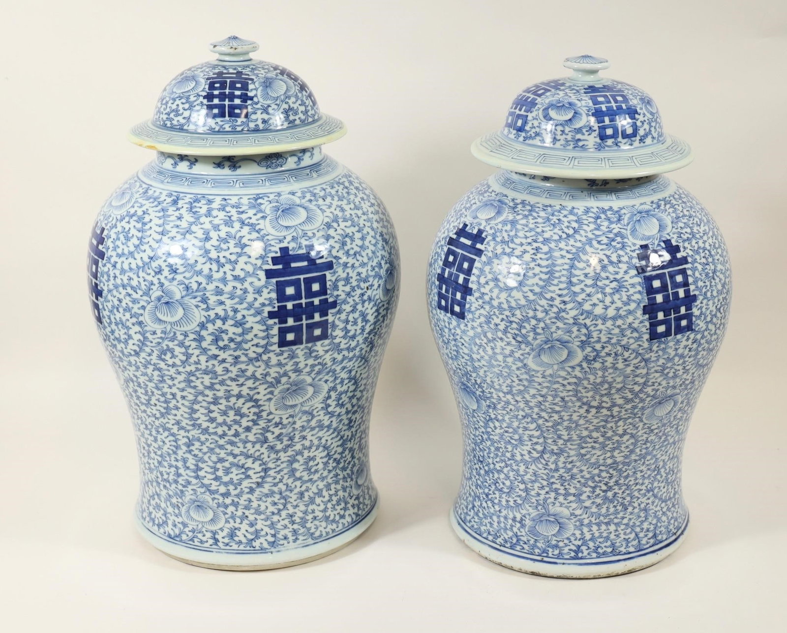 19th C. Chinese Double Happiness Ginger Jars Pair: Antique 19th-century Chinese blue and white porcelain ginger jars with matching lids, decorated with intricate floral scrollwork and prominent Double Happiness () symbols. Finely executed in a traditi