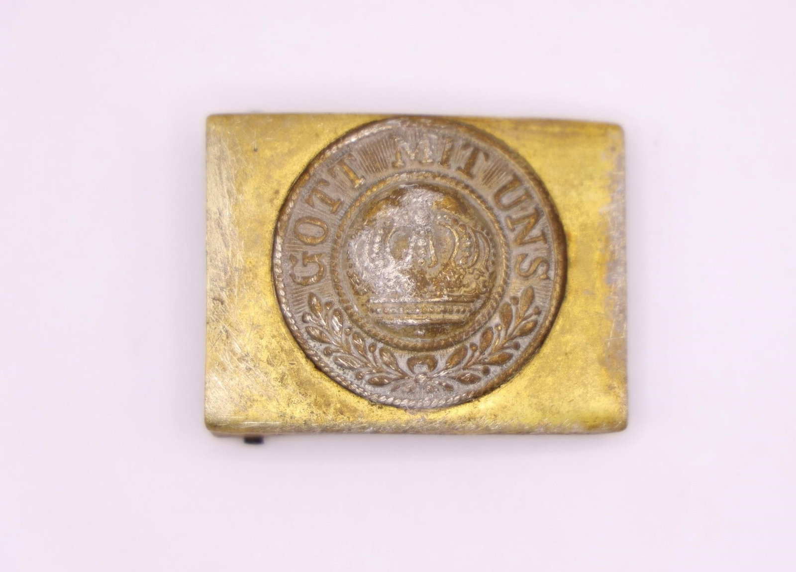 German Brass Belt Buckle with Prussian Crown: German belt buckle featuring a brass construction with a central nickel disc displaying a Prussian crown and the inscription "Gott mit uns" ("God With Us"). Exhibits age-related wear, patina, and char