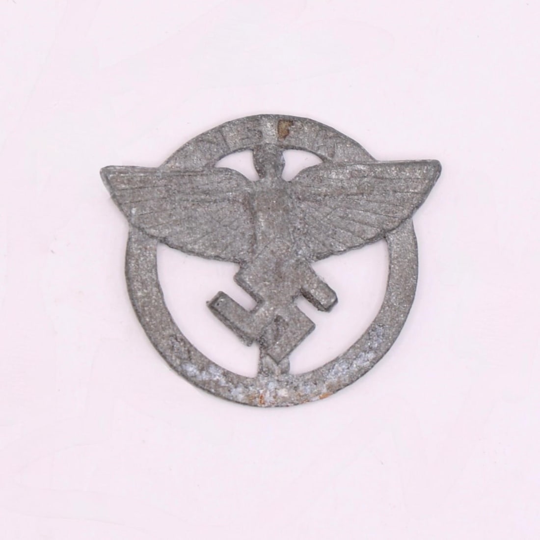 NSFK Member's Badge: This is a metal badge from the National Socialist Flyers Corps (NSFK), a paramilitary aviation organization active in Germany at the time. It features the group's winged-figure emblem within a circula