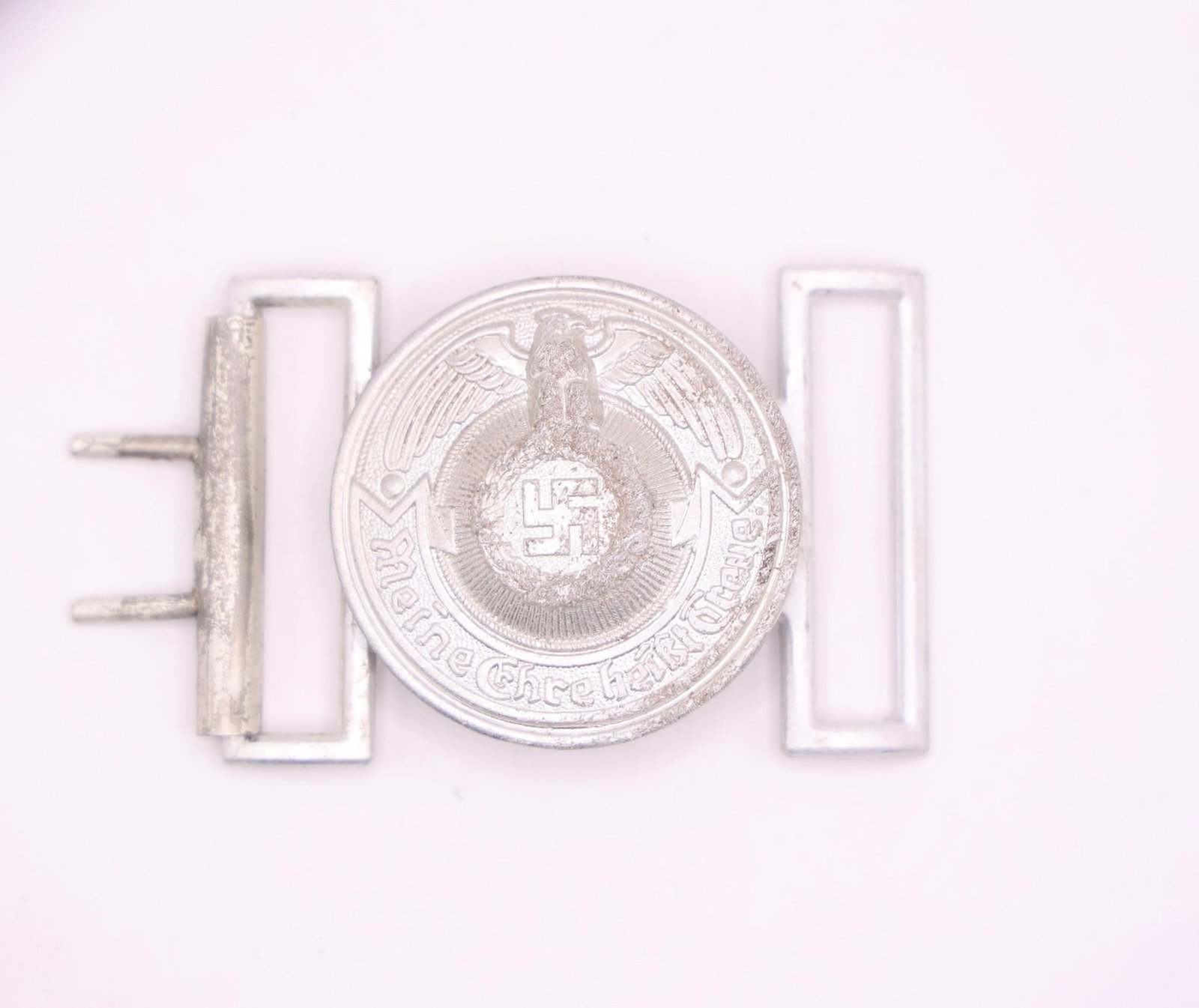 WWII German Military Belt Buckle: Original period German military belt buckle featuring historically significant insignia associated with World War II. Metal construction with age-related wear, patina, oxidation, and handling marks co